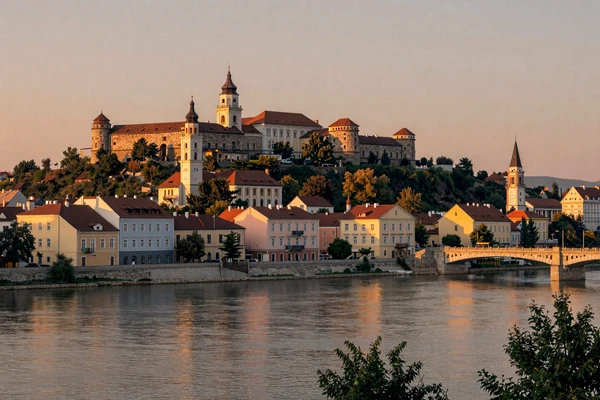 Petrovaradin Fortress and Danube River in Novi Sad Serbia at golden sunset reflecting warm light on the water
